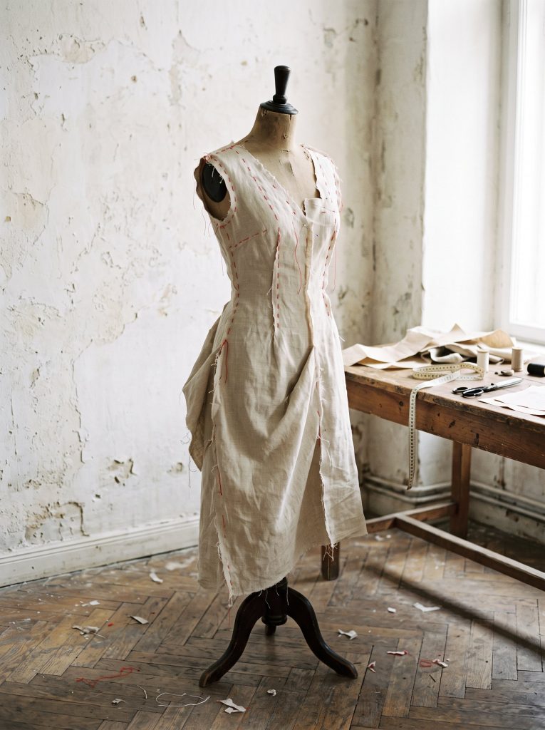 Mannequin de couture ancien portant une robe en cours de montage, faufil rouge sur les coutures