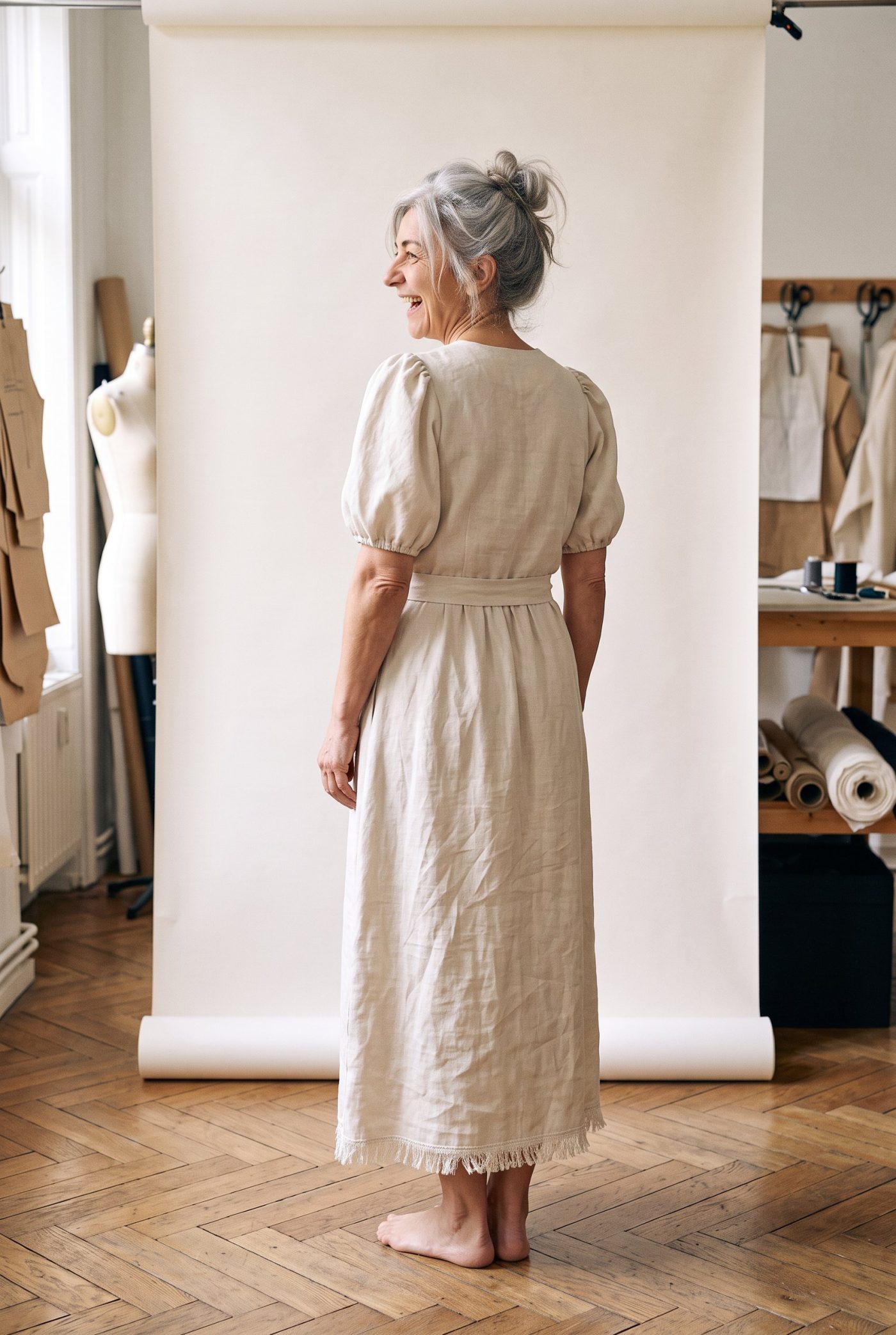 Robe de mariée Lisière vue de dos, devant un fond de papier écru
